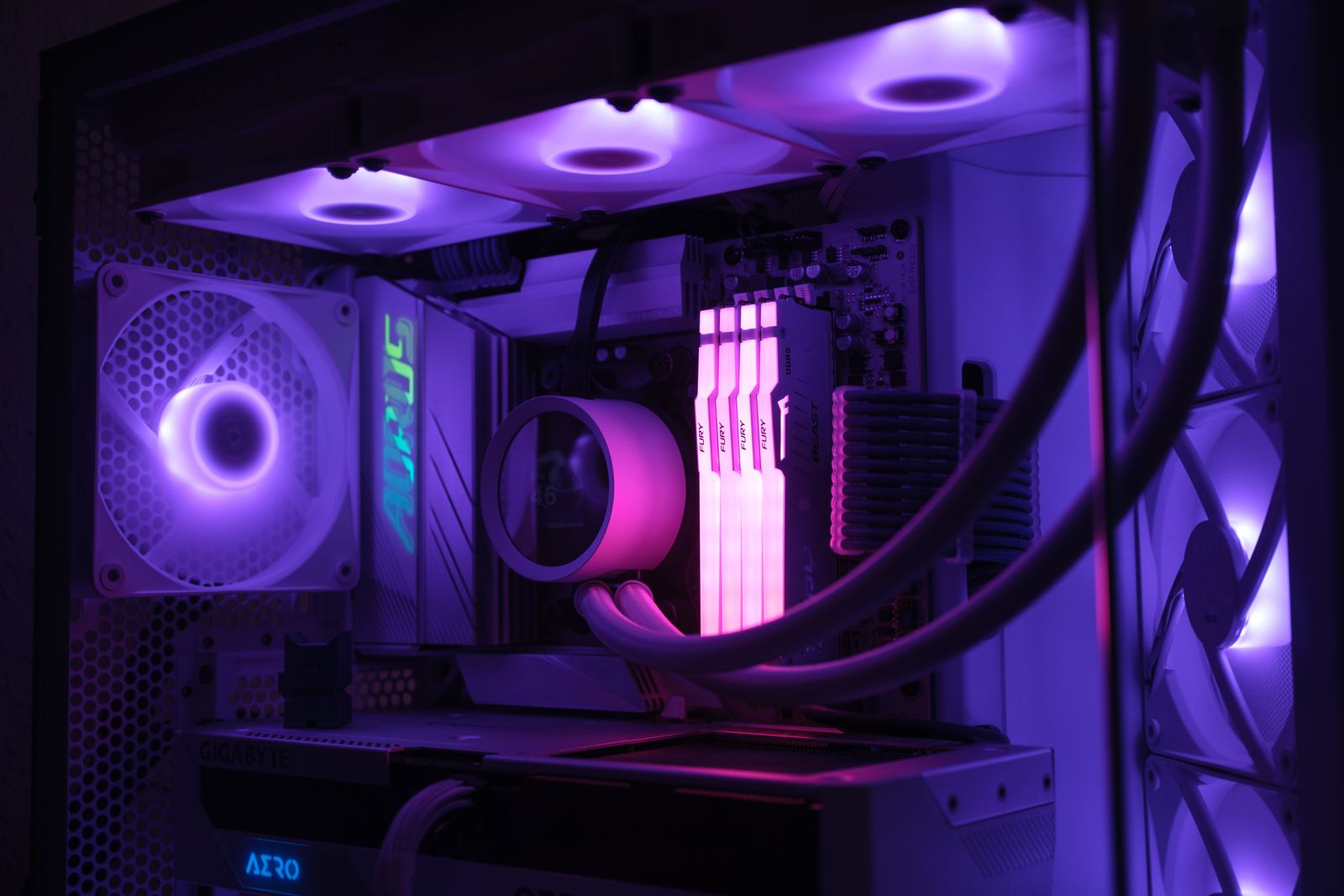 Interior of an assembled gaming PC with RGB-lit fans, memory, and cooling